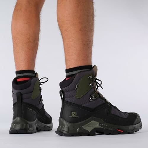 Person wearing black hiking boots